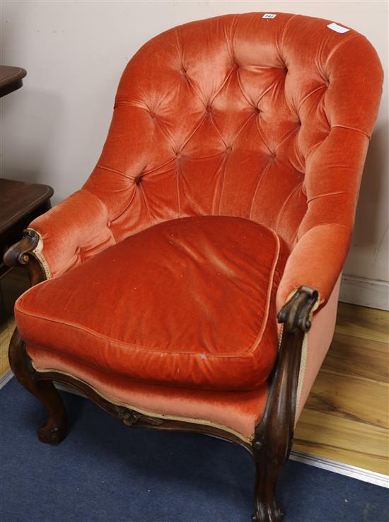 A Victorian walnut framed open armchair with salmon pink upholstery